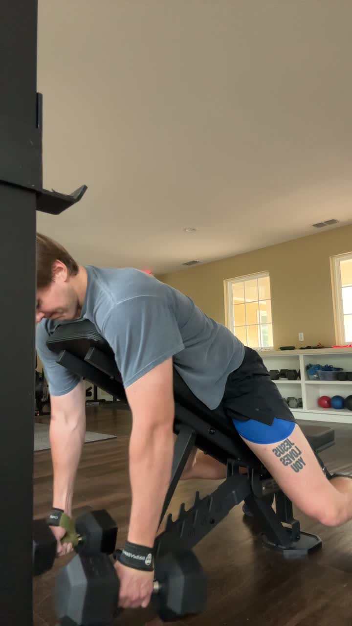 Spencer performing a chest-supported dumbbell row